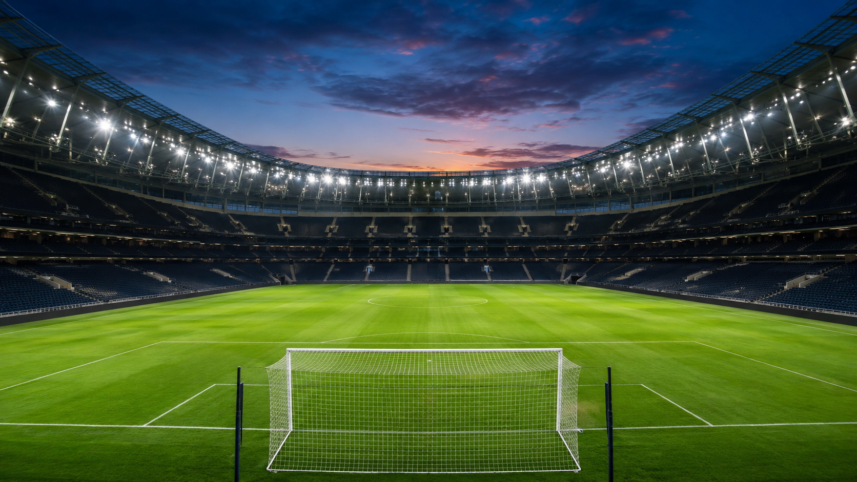 Un stade de football illuminé et vide au crépuscule, juste avant le coup d'envoi