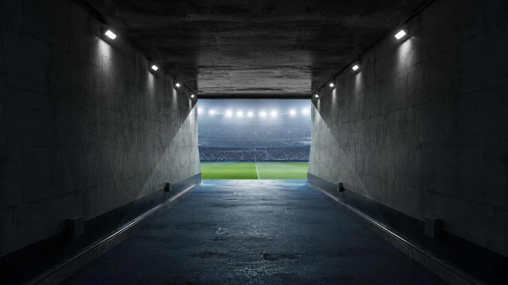 Tunnel d'un stade de football menant vers la pelouse baignée de lumière