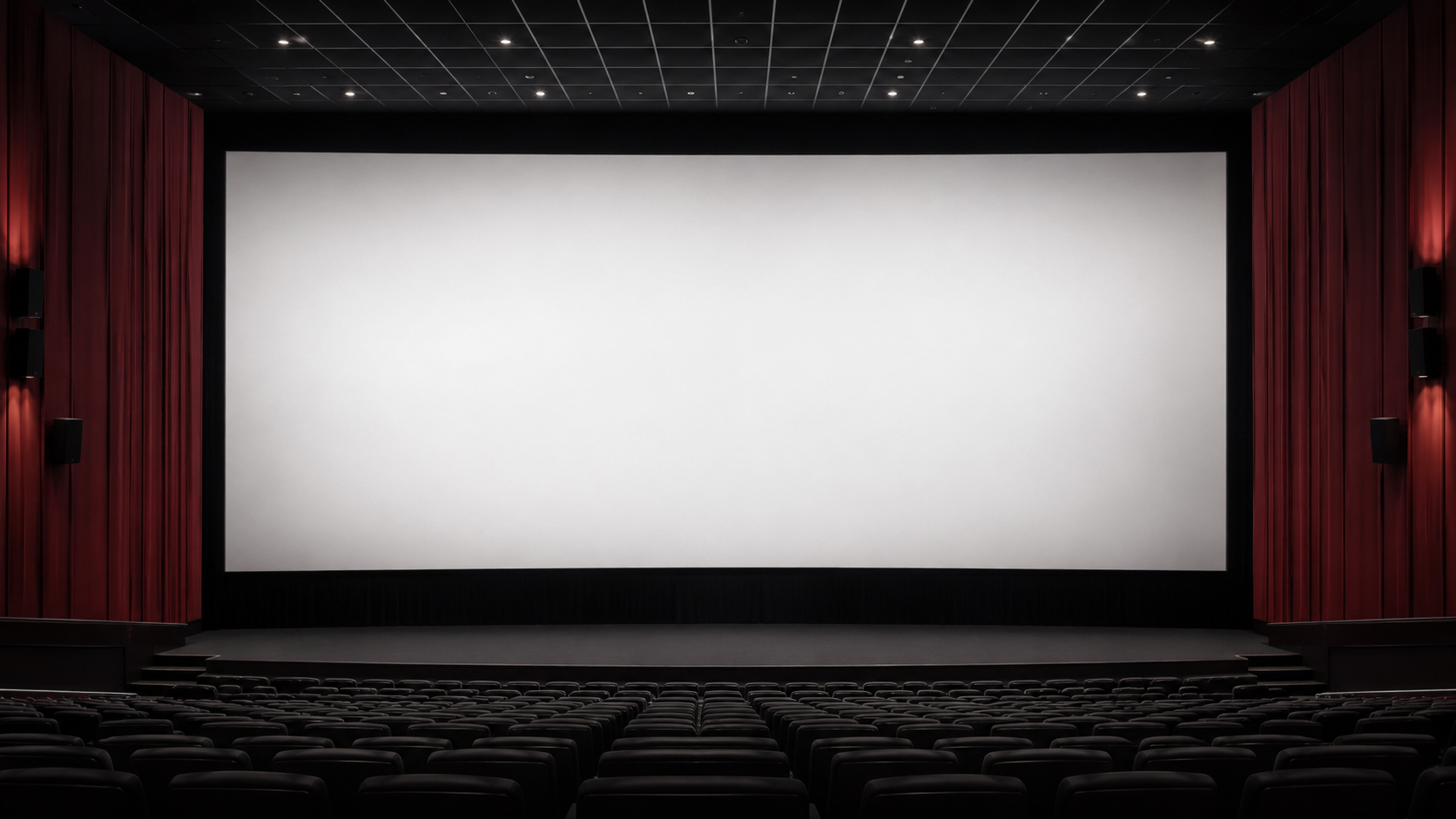 Grande salle IMAX avec un écran blanc géant et vide